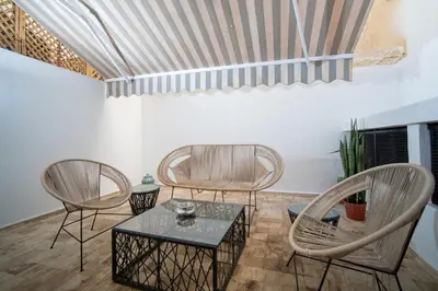 a living room with two chairs and a table at Studio chic- les princesses Maarif in Casablanca