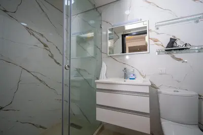 a bathroom with a shower and a toilet and a sink at Studio chic- les princesses Maarif in Casablanca