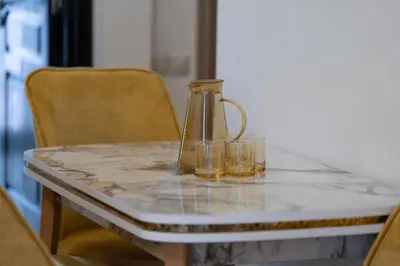 a table with a glass pitcher and two glasses on it at Studio chic- les princesses Maarif in Casablanca