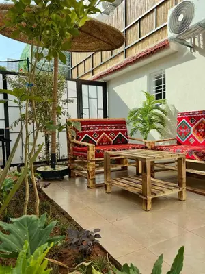 a patio with couches and a bench in a courtyard at Villa 3 Corniche, Charming Seaside Villa with Jacuzzi, Carrousel Mall Rabat in Rabat