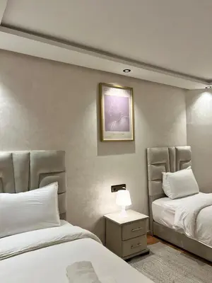 a bedroom with two beds and a table with a lamp at Villa 3 Corniche, Charming Seaside Villa with Jacuzzi, Carrousel Mall Rabat in Rabat