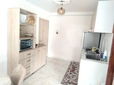 a kitchen with a refrigerator and a microwave at Charmant appartement à Casablanca Près tram & gare in Casablanca
