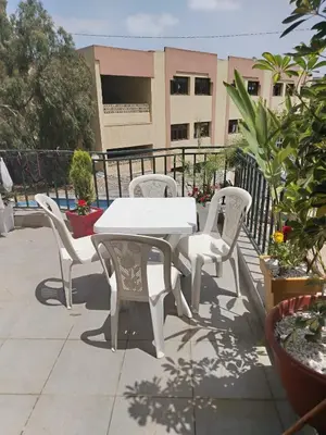 a white table and chairs on a patio at Charmant appartement à Casablanca Près tram & gare in Casablanca