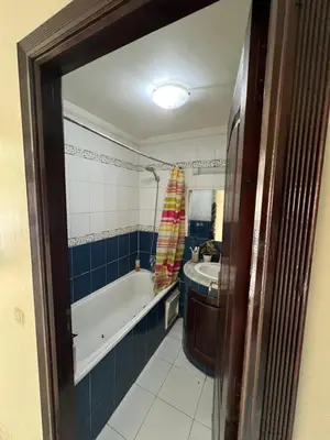 a bathroom with a bath tub and a sink at Chambre zuiten in Casablanca