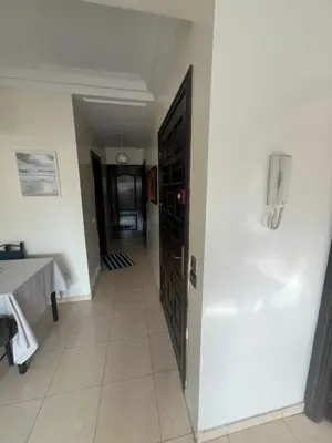 a hallway with a door to a room with a table at Chambre zuiten in Casablanca