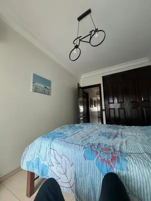 a bedroom with a bed with a blue comforter at Chambre zuiten in Casablanca