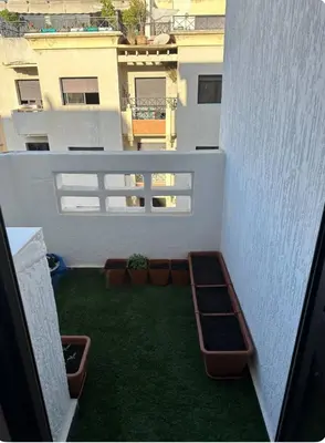 a balcony with a yard with plants on it at Rabat Agdal apartment in Rabat