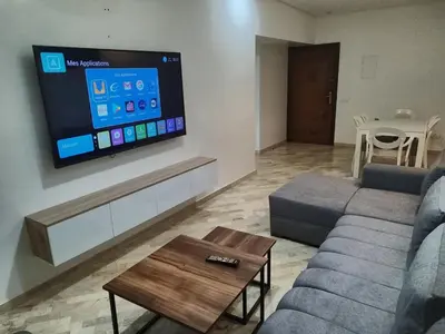 a living room with a couch and a flat screen tv at Apartment 2 rooms in Agdal in Rabat