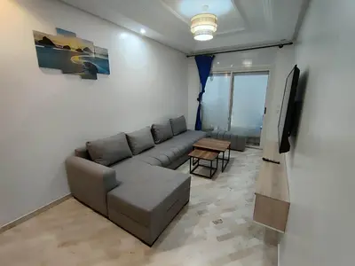 a living room with a couch and a flat screen tv at Apartment 2 rooms in Agdal in Rabat