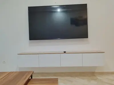 a flat screen tv hanging on a white wall at Apartment 2 rooms in Agdal in Rabat