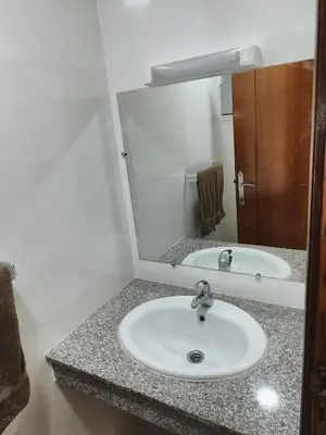 a bathroom with a sink and a mirror at Apartment 2 rooms in Agdal in Rabat
