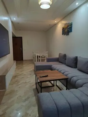 a living room with a couch and a table at Apartment 2 rooms in Agdal in Rabat