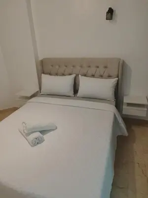 a white bed with a white foot board on it at Apartment 2 rooms in Agdal in Rabat