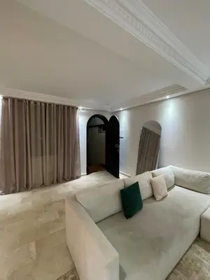 a living room with a white couch in a room at 2-bedroom duplex for rent in Temara