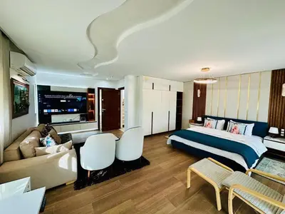 a hotel room with a bed and a couch at Villa de luxe avec piscine et jardin privés in Temara