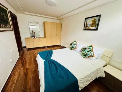 a bedroom with a large bed in a room at Villa de luxe avec piscine et jardin privés in Temara