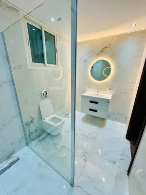a white bathroom with a toilet and a sink at Villa de luxe avec piscine et jardin privés in Temara