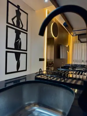 a bathroom with a sink and a stove at ARENA 41- Maarif in Casablanca