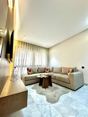 a living room with a couch and a table at ARENA 41- Maarif in Casablanca