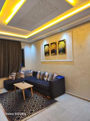 a living room with a couch and a table at Appartement ainsbaa in Casablanca