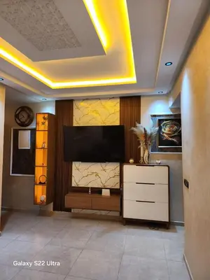 a living room with a flat screen tv on a wall at Appartement ainsbaa in Casablanca