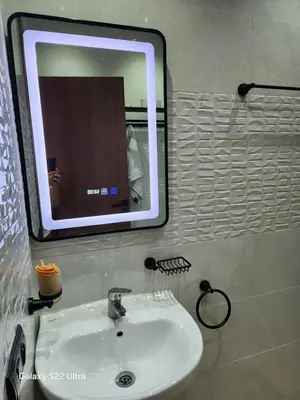 a bathroom sink with a large mirror above it at Appartement ainsbaa in Casablanca