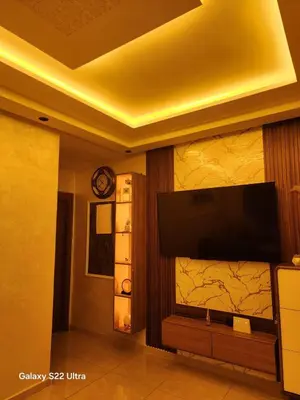 a living room with a flat screen tv on a wall at Appartement ainsbaa in Casablanca