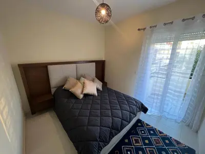 a bedroom with a bed with two pillows on it at Magnifique Appartement Bahia Golf Beach in Bouznika
