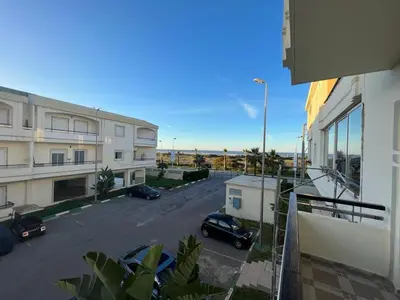 a view of a street with cars parked in a parking lot at Magnifique Appartement Bahia Golf Beach in Bouznika
