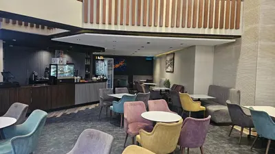a restaurant with tables and chairs and a bar at Beautiful 3-Bedroom Apartment in Maarif, Spacious Living for Families, Groups & Business Travelers in Casablanca