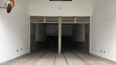 an empty room with wooden doors in a building at Beautiful 3-Bedroom Apartment in Maarif, Spacious Living for Families, Groups & Business Travelers in Casablanca
