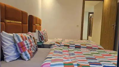 a bedroom with a bed with a colorful comforter at Beautiful 3-Bedroom Apartment in Maarif, Spacious Living for Families, Groups & Business Travelers in Casablanca