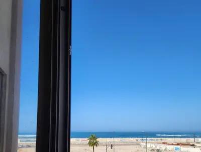 a view of the beach from a window at Elegant Lateral Beachfront Family Stay in Casablanca