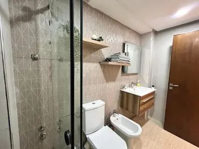 a bathroom with a toilet and a shower and a sink at Elegant Lateral Beachfront Family Stay in Casablanca