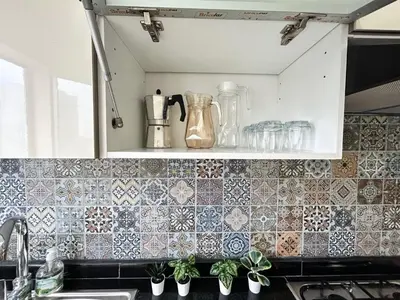 a kitchen with a counter top with tiles on the wall at Elegant Lateral Beachfront Family Stay in Casablanca