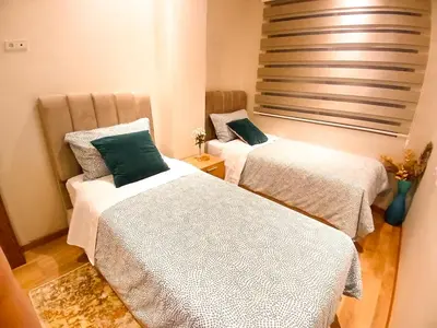 a room with two beds and a window at Elegant Lateral Beachfront Family Stay in Casablanca