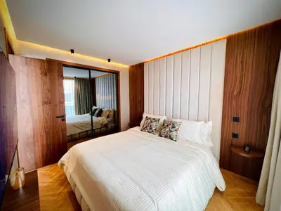 a bedroom with a large white bed and a mirror at Rafina in Casablanca