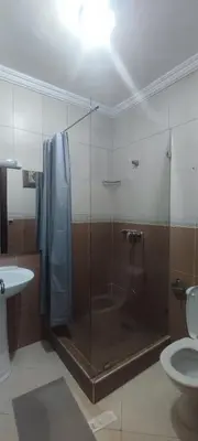a bathroom with a shower with a glass door at Appartement Jamila in Rabat