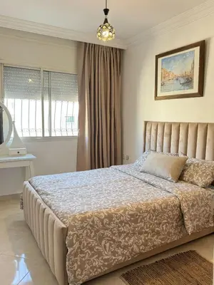 a bedroom with a large bed in a room at Appartement Jamila in Rabat