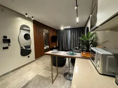 a kitchen with a table and a microwave at Rafina in Casablanca