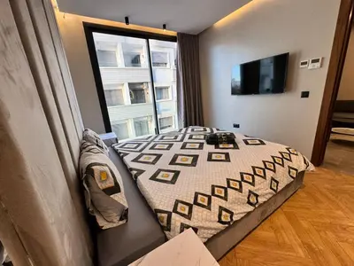 a bedroom with a bed and a large window at Rafina in Casablanca