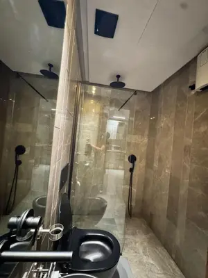 a bathroom with a toilet and a man in a shower at Rafina in Casablanca