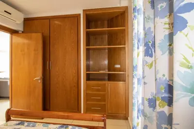 a closet with wooden cabinets in a room at Magnifique studio cosy et lumineux avec vue sur mer in Tamaris