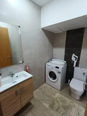 a bathroom with a washing machine and a sink at GARDEN BAY Appartement Luxe Front de Mer à Tamaris Sidi Rahal, Plage Privée, Piscine et Loisirs in Tamaris