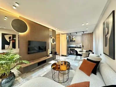 a living room with a couch and a table at Cosy Central Studio with balcony Maarif - Near Twin Center in Casablanca