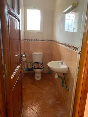 a bathroom with a toilet and a sink at Bouznika 100m2 Piscineplage in Bouznika