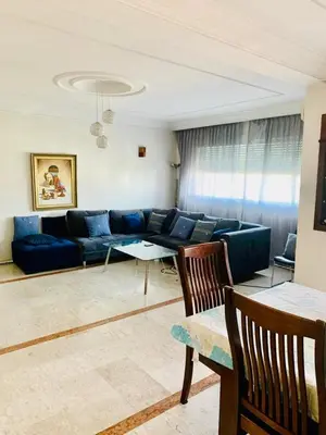a living room with a blue couch and a table at Rabat Hay Riad 3 Ideal Rooms in Rabat
