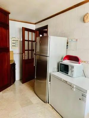 a kitchen with a refrigerator and a microwave on a counter at Rabat Hay Riad 3 Ideal Rooms in Rabat