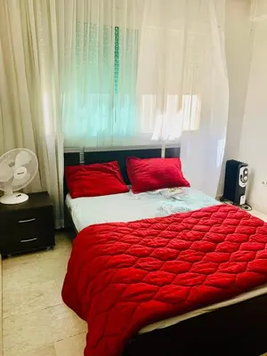 a bedroom with a bed with red pillows and a window at Rabat Hay Riad 3 Ideal Rooms in Rabat