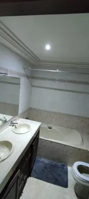 a bathroom with two sinks and a bath tub at Rabat Hay Riad 3 Ideal Rooms in Rabat
